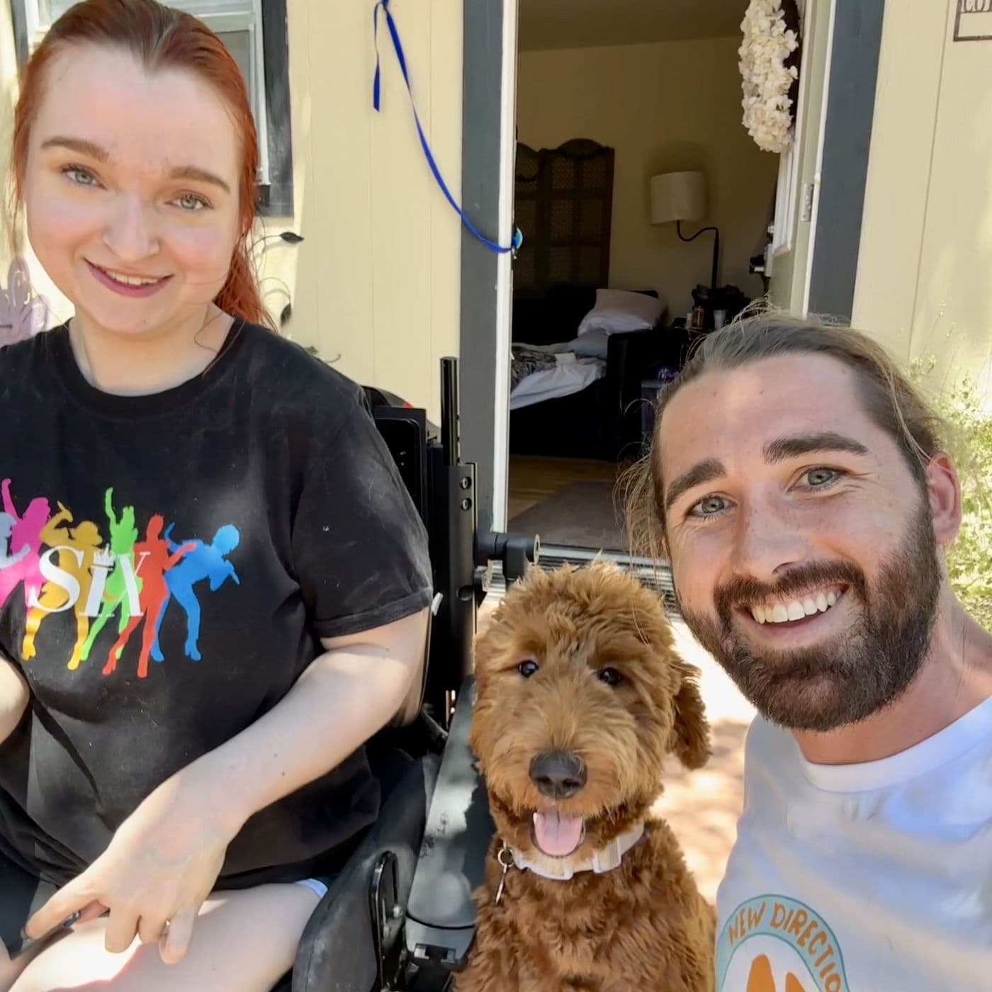 Brady from New Direction Dog Training with a client in her power chair and her goldendoodle